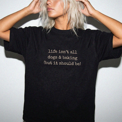 Model wearing a Black Comfort Colors® T-shirt showing dog-themed baking graphic