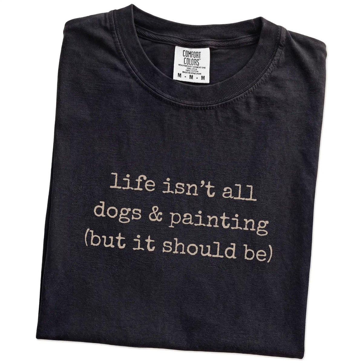 Folded Black Comfort Colors® T-shirt showing dog-themed painting graphic