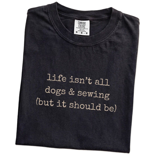 Folded Black Comfort Colors® T-shirt showing dog-themed sewing graphic