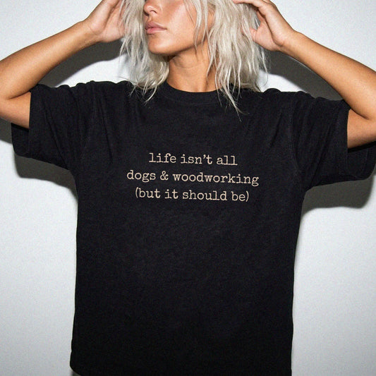 Model wearing a Black Comfort Colors® T-shirt showing dog-themed woodworking graphic