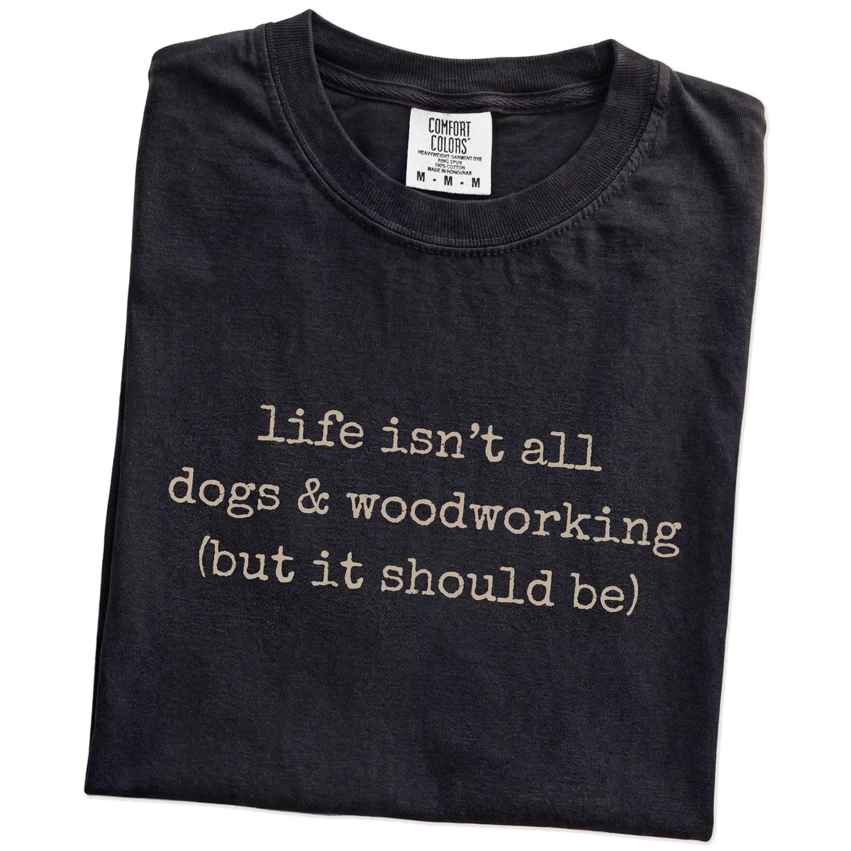 Folded Black Comfort Colors® T-shirt showing dog-themed woodworking graphic