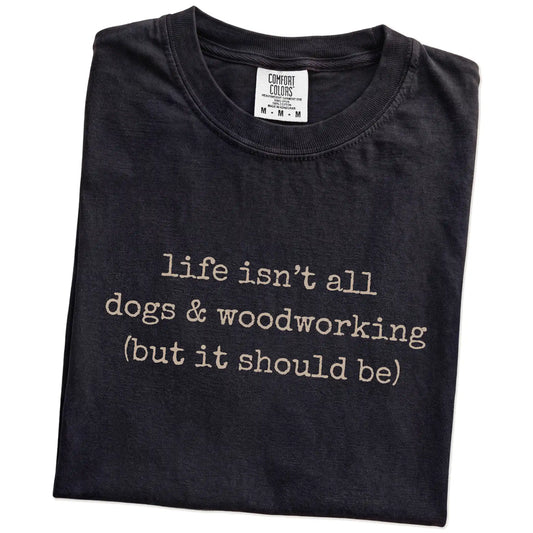 Folded Black Comfort Colors® T-shirt showing dog-themed woodworking graphic