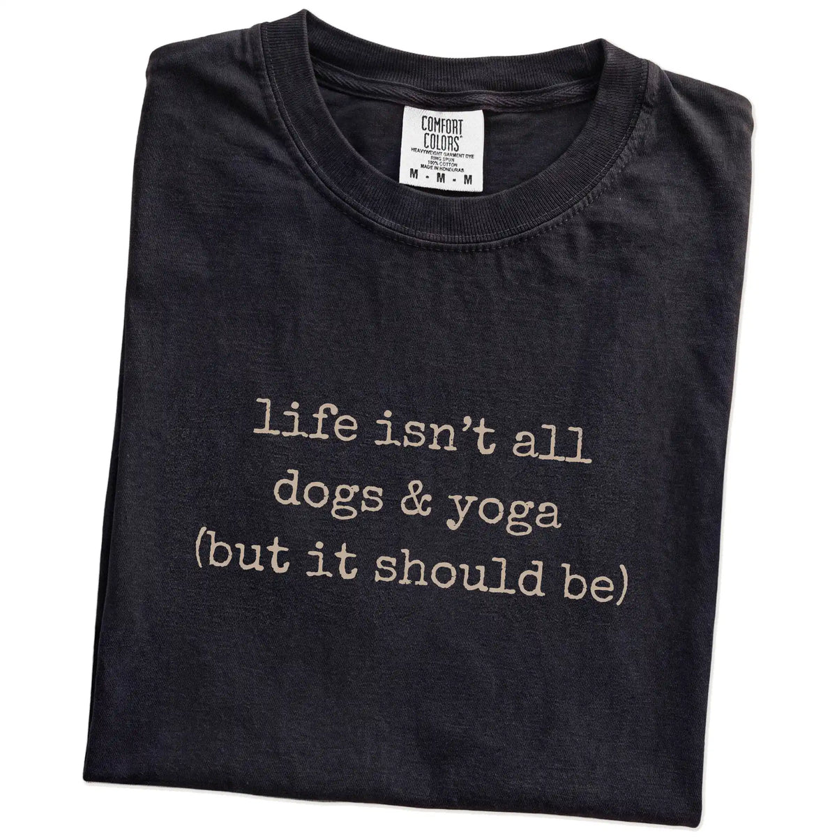 Folded Black Comfort Colors® T-shirt showing dog-themed yoga graphic