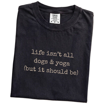 Folded Black Comfort Colors® T-shirt showing dog-themed yoga graphic