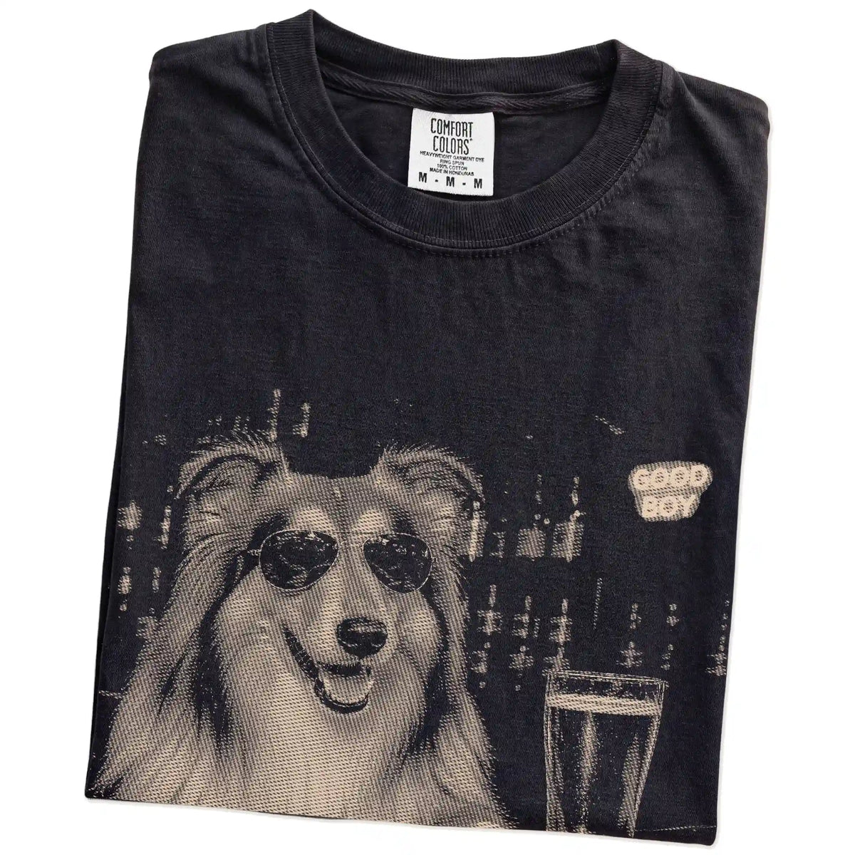 Black Collie at a bar beside a pint, folded detail view