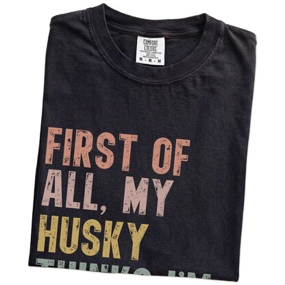 Folded Black Comfort Colors® T-shirt showing “My Husky thinks I’m delightful” text