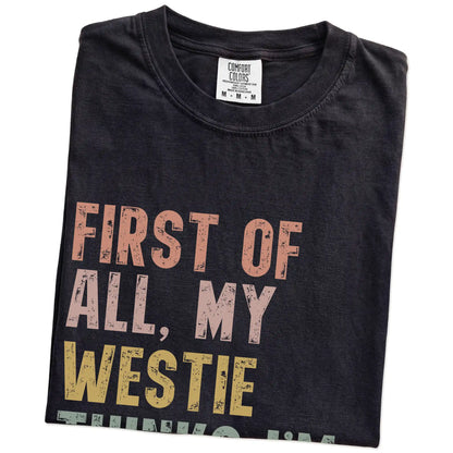 Folded Black Comfort Colors® T-shirt showing “My Westie thinks I’m delightful” text