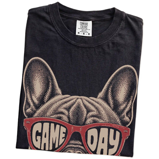 Folded Black Comfort Colors® T-shirt showing french bulldog wearing red game day sunglasses