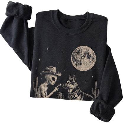 Black crewneck sweatshirt featuring German Shepherd Cowboy and Alien, folded presentation