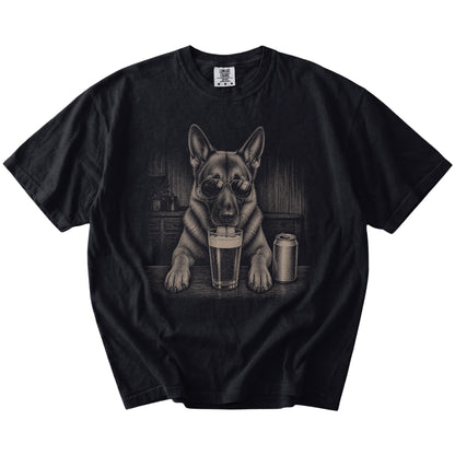 German Shepherd sneaking a drink from a foamy pint at home on a Black Comfort Colors® t-shirt