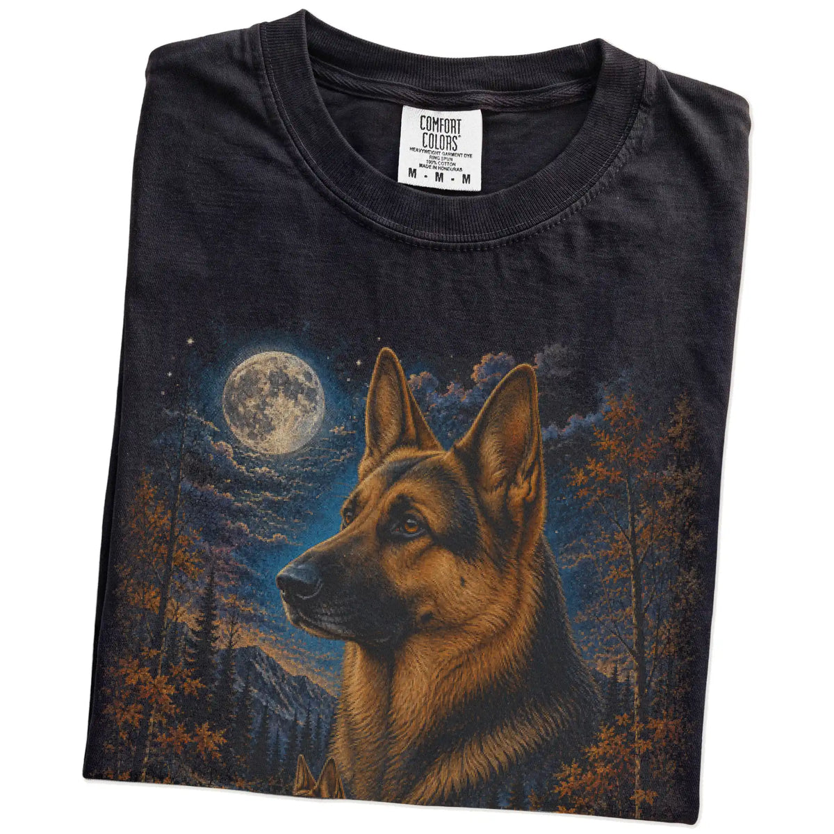 Folded Black Comfort Colors® t-shirt showing German Shepherd in a fall forest graphic