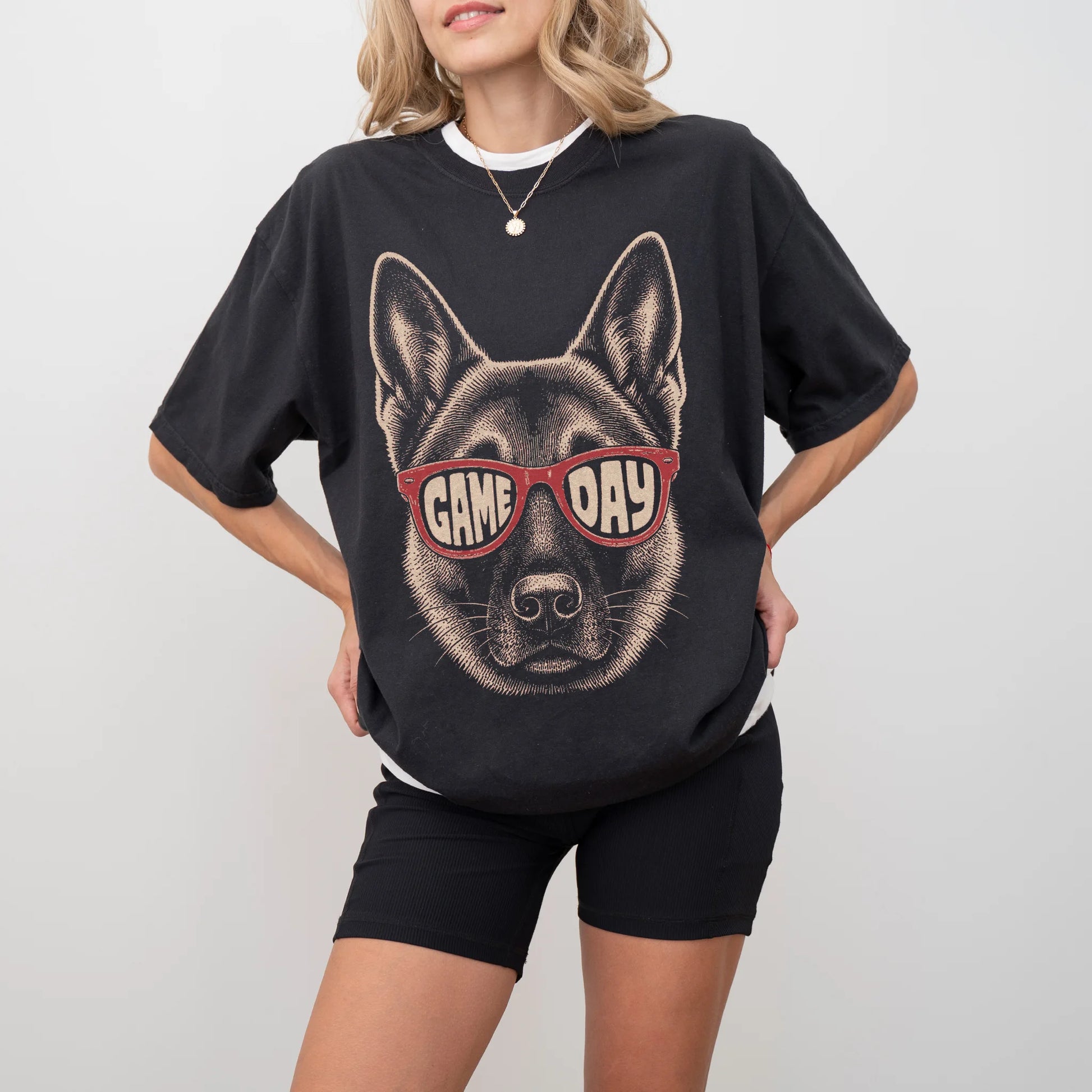 Model wearing a Black Comfort Colors® T-shirt with german shepherd wearing red game day sunglasses