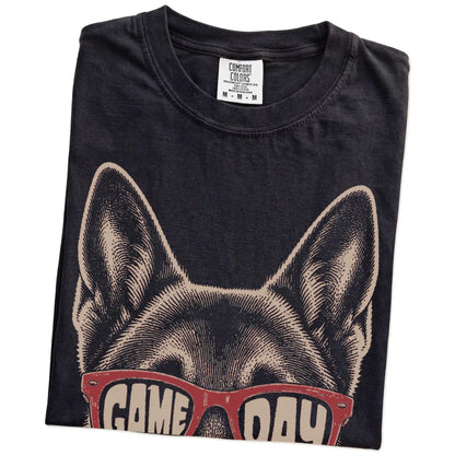 Folded Black Comfort Colors® T-shirt showing german shepherd wearing red game day sunglasses