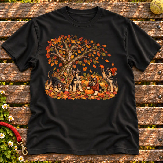 Four German Shepherd puppies with pumpkins beneath an autumn tree on a Black softstyle T-shirt