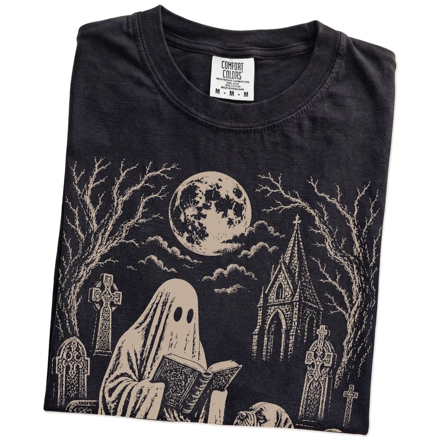 Folded Black Comfort Colors® T-shirt showing Mastiff beside a reading ghost in a moonlit graveyard