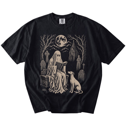 Whippet beside a reading ghost in a moonlit graveyard on a Black Comfort Colors® T-shirt