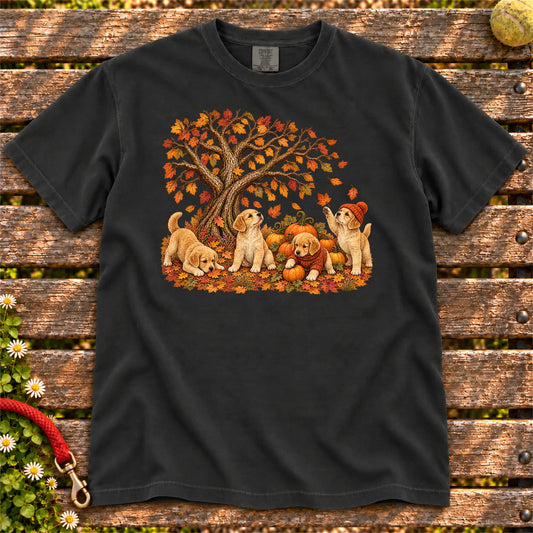 Four Golden Retriever puppies with pumpkins beneath an autumn tree on a Black garment-dyed T-shirt