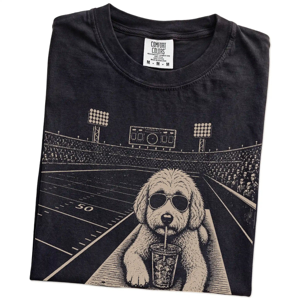Folded Black Comfort Colors® T-shirt showing Goldendoodle ready for football and tailgate season
