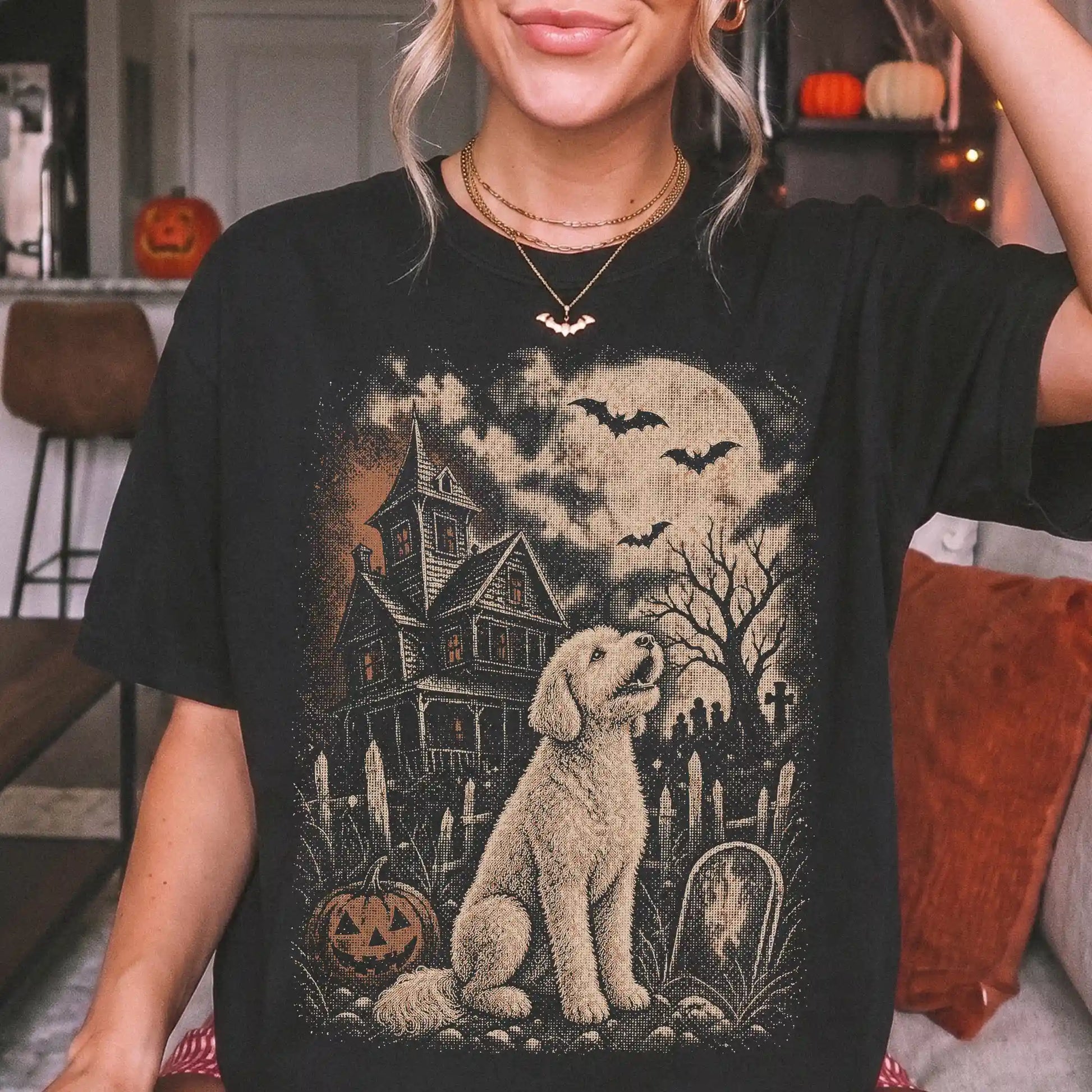 Model wearing a Black Comfort Colors® T-shirt showing Goldendoodle in a vintage haunted-house scene