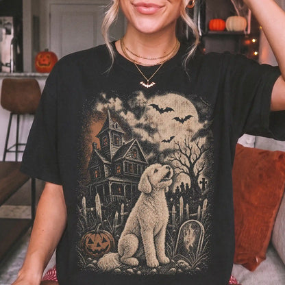 Model wearing a Black Comfort Colors® T-shirt showing Goldendoodle in a vintage haunted-house scene