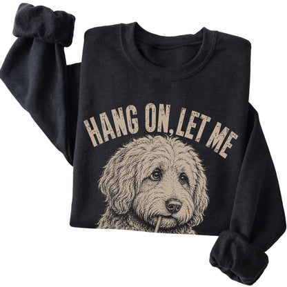 Black crewneck sweatshirt featuring Overthinking Goldendoodle, folded presentation