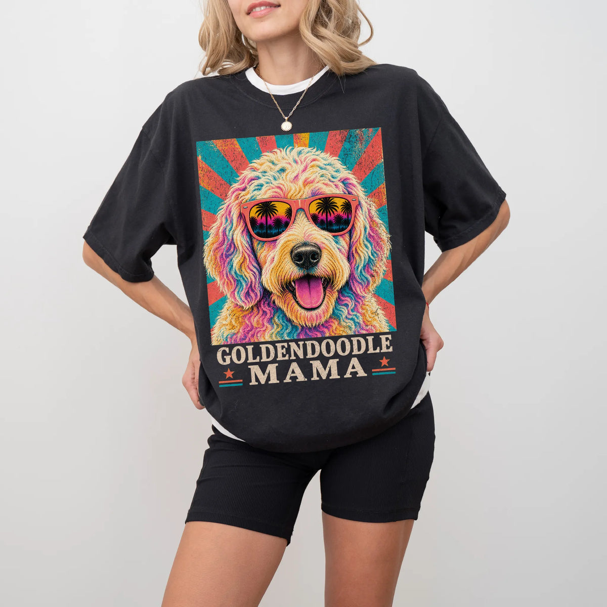 Retro Goldendoodle Mama design on a Black Comfort Colors T-shirt worn by a model