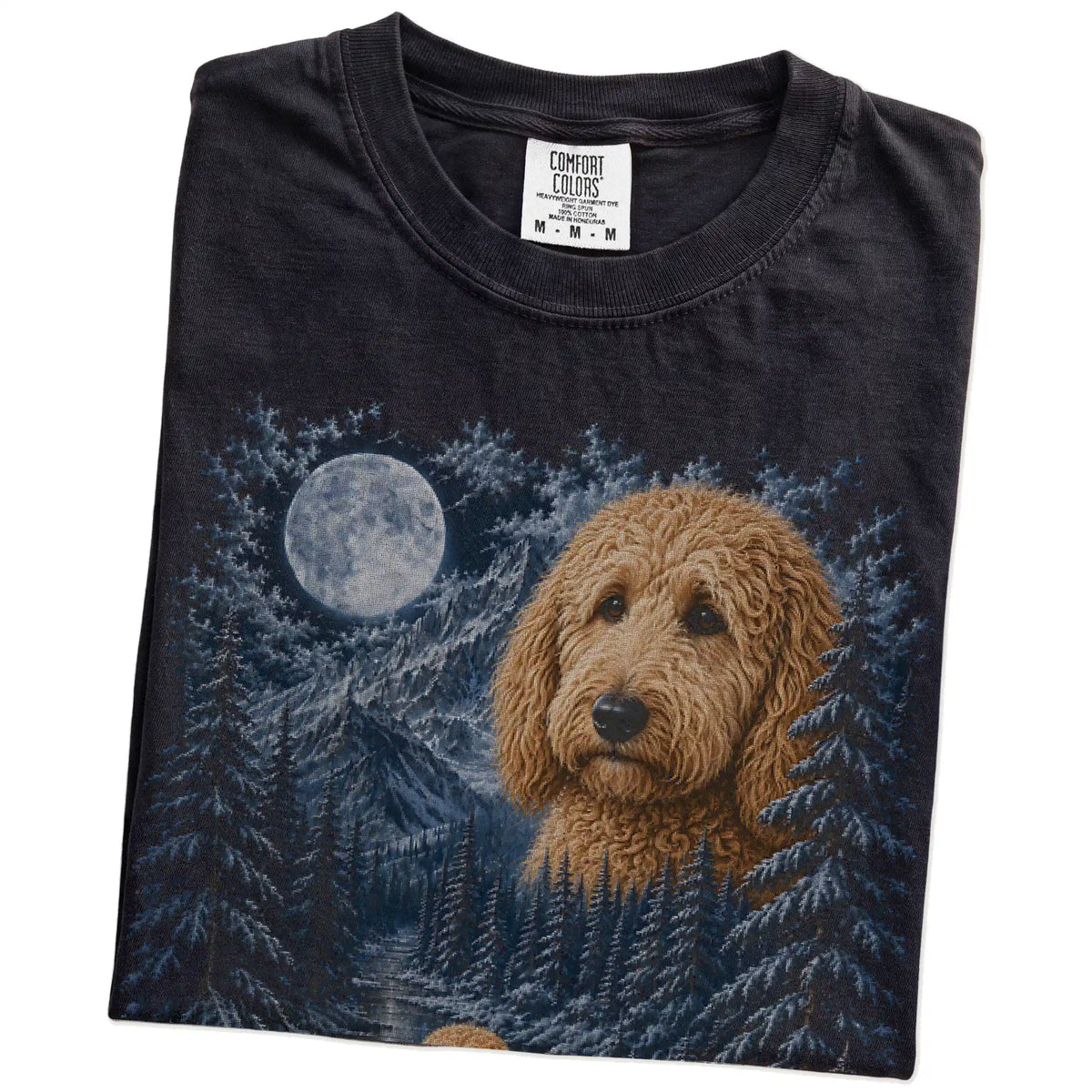 Folded black T-shirt with Goldendoodle Winter Moon artwork.
