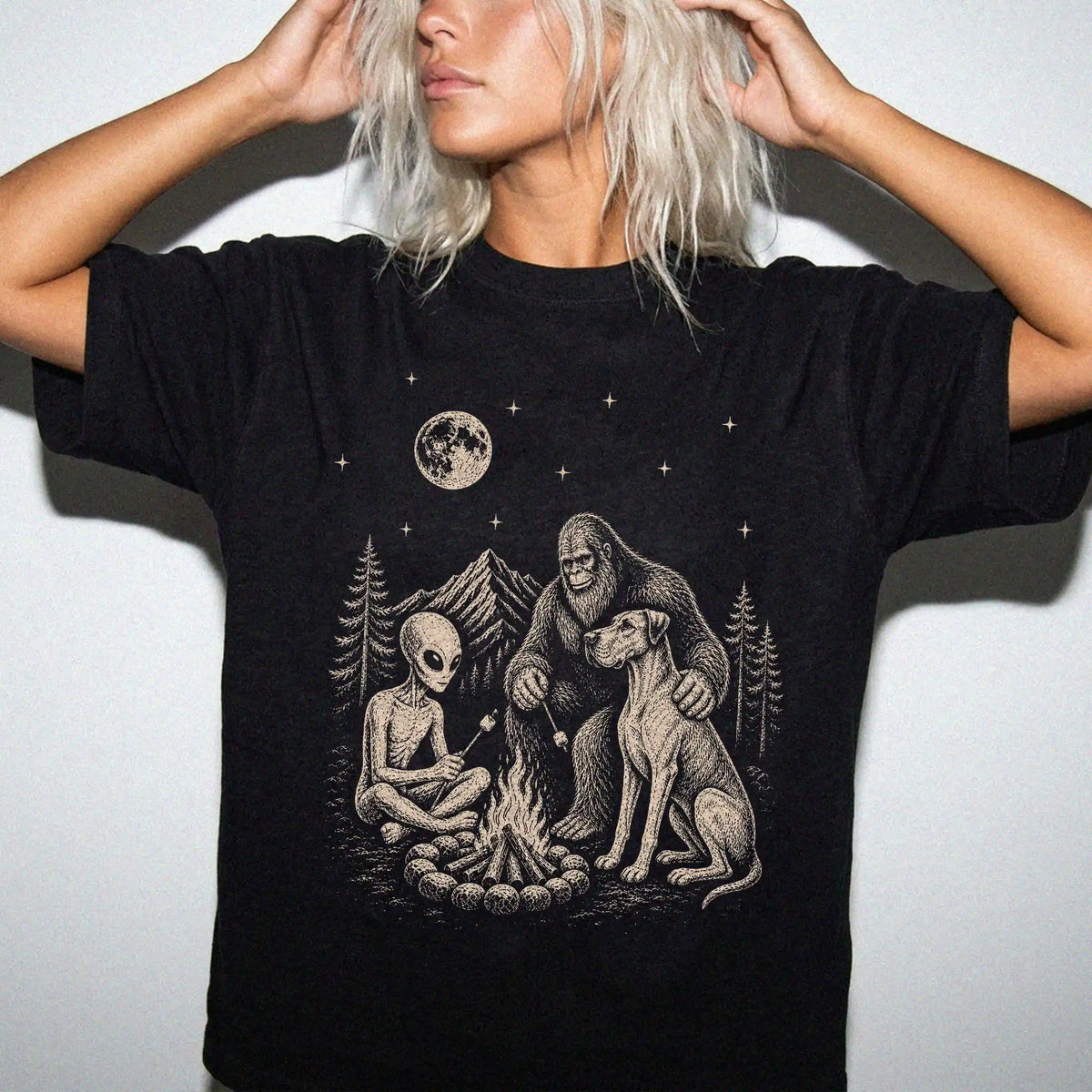 Model wearing a Black Comfort Colors® T-shirt showing Great Dane camping with Bigfoot and an alien