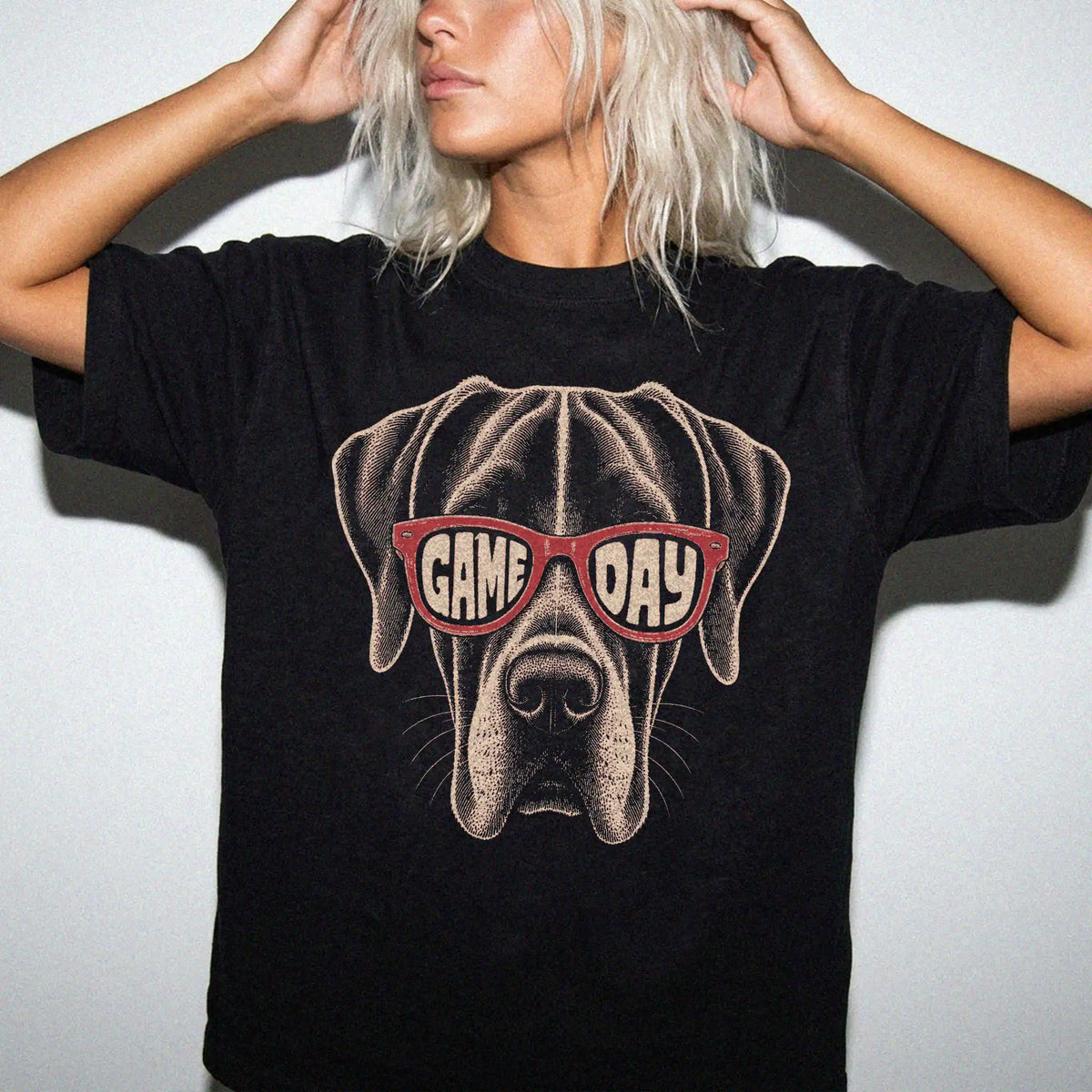 Model wearing a Black Comfort Colors® T-shirt with great dane wearing red game day sunglasses