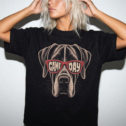 Model wearing a Black Comfort Colors® T-shirt with great dane wearing red game day sunglasses