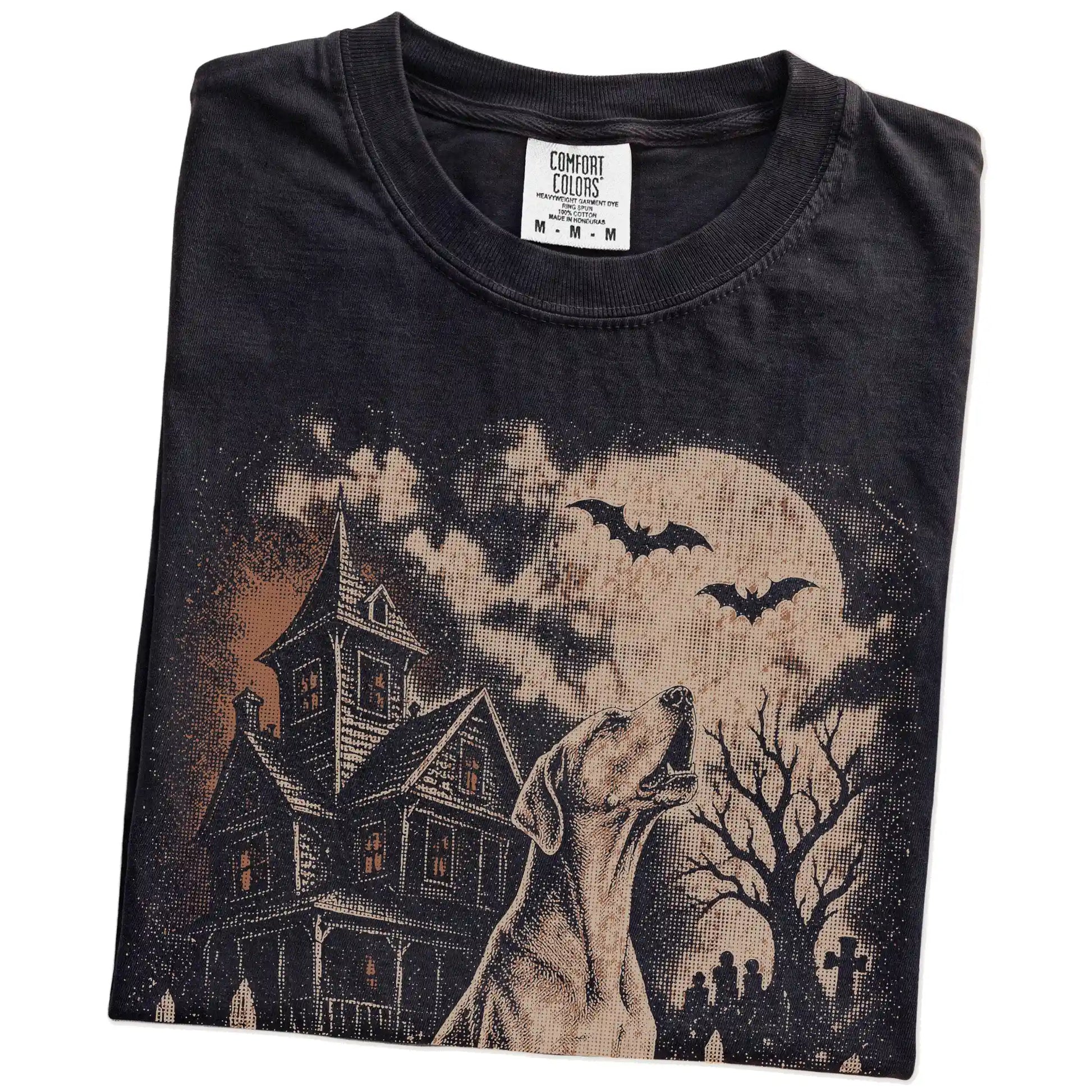 Folded Black Comfort Colors® T-shirt showing Great Dane in a vintage haunted-house scene