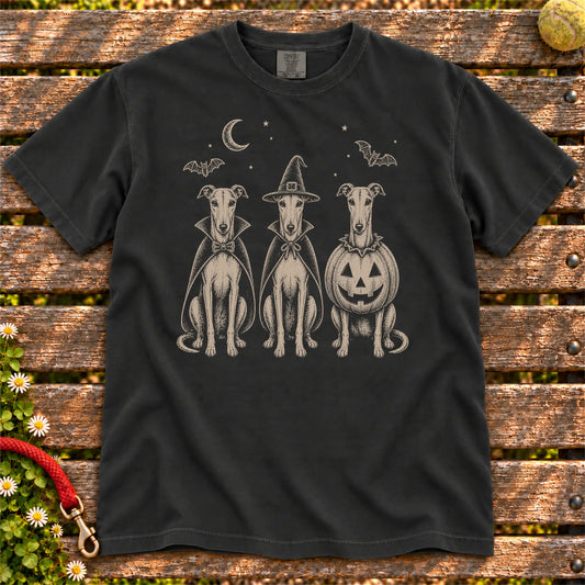 Three Greyhound dogs dressed for Halloween beneath bats and a crescent moon on a Black Comfort Colors® T-shirt
