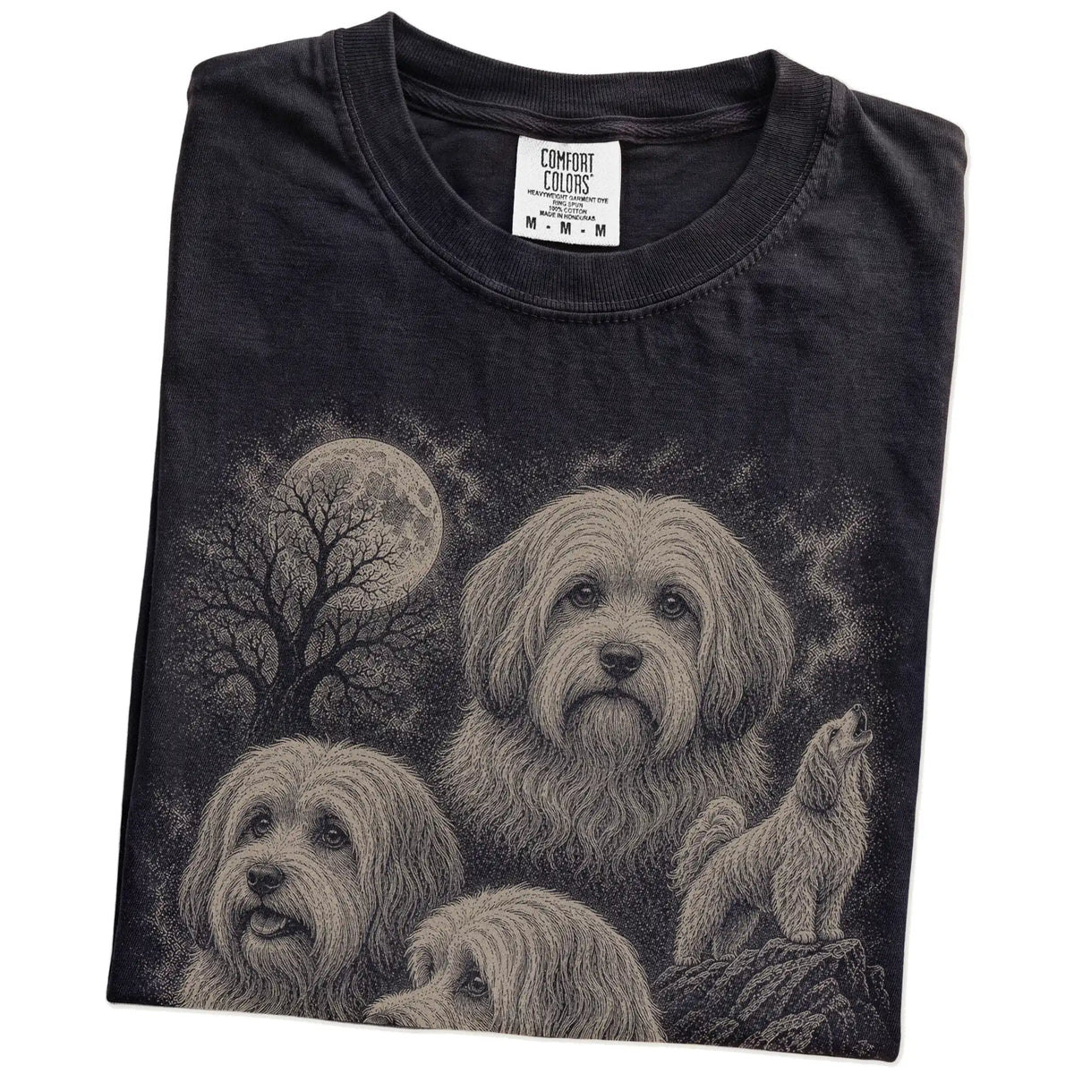 Folded Black Comfort Colors® T-shirt showing a vintage moon montage featuring Havanese