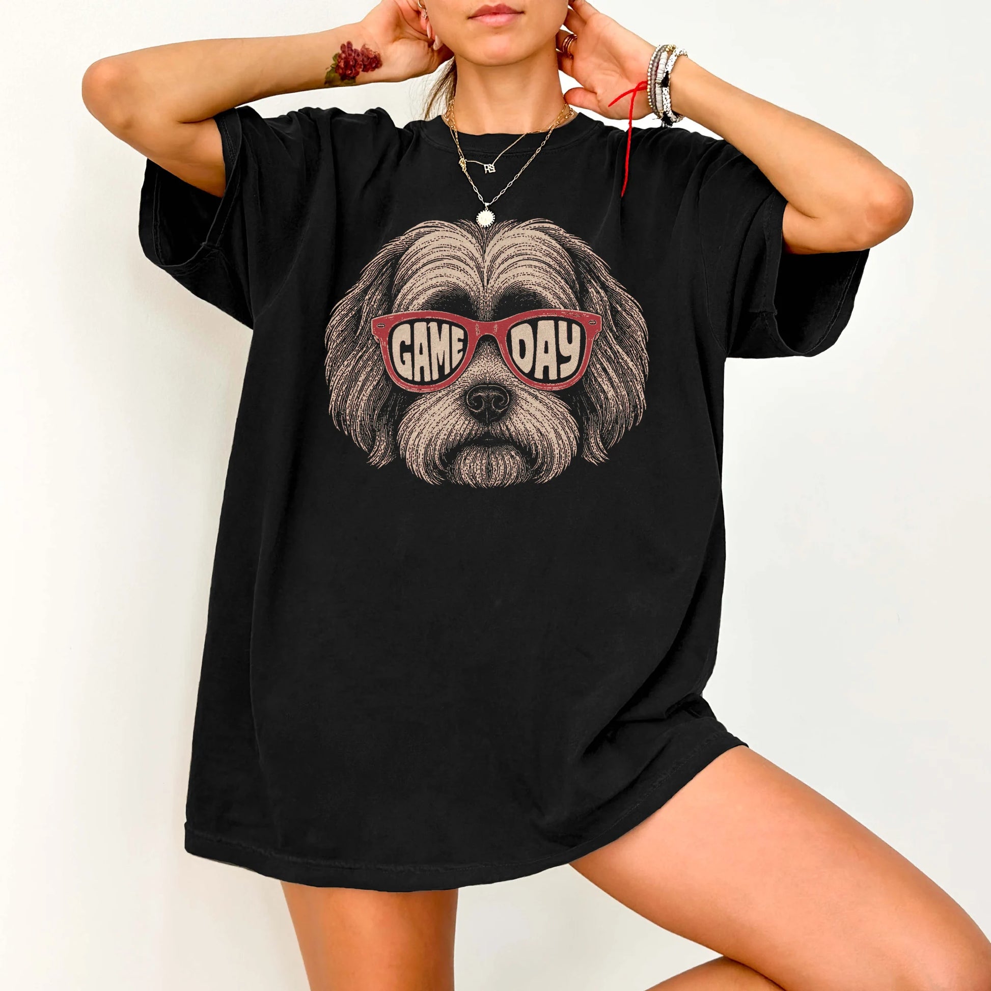 Model wearing a Black Comfort Colors® T-shirt with havanese wearing red game day sunglasses