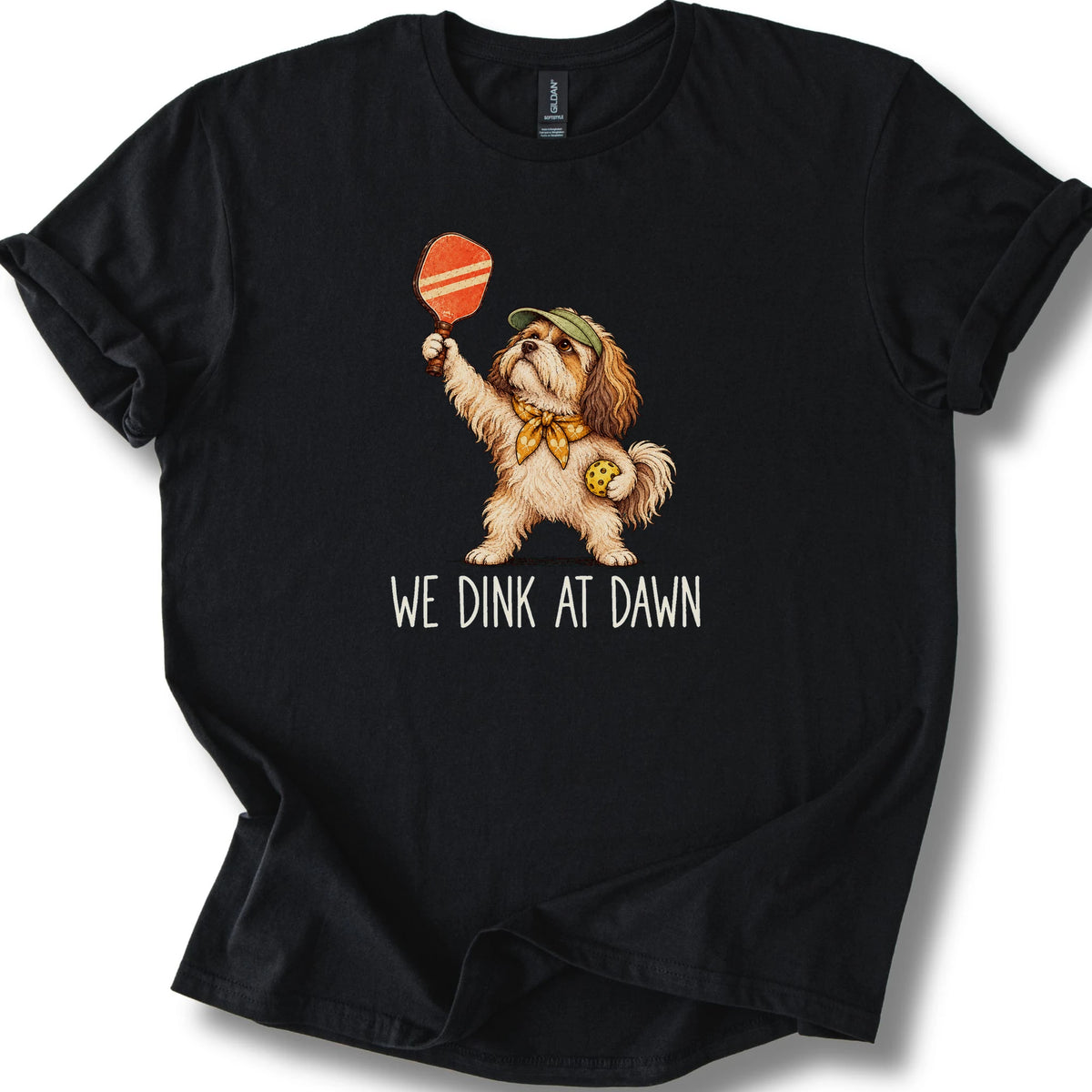 Havanese with a pickleball paddle and ball on a Black Gildan® T-shirt with We Dink at Dawn text