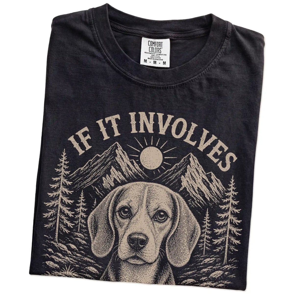 Folded Black Comfort Colors® T-shirt showing Beagle hiking design with mountain scenery