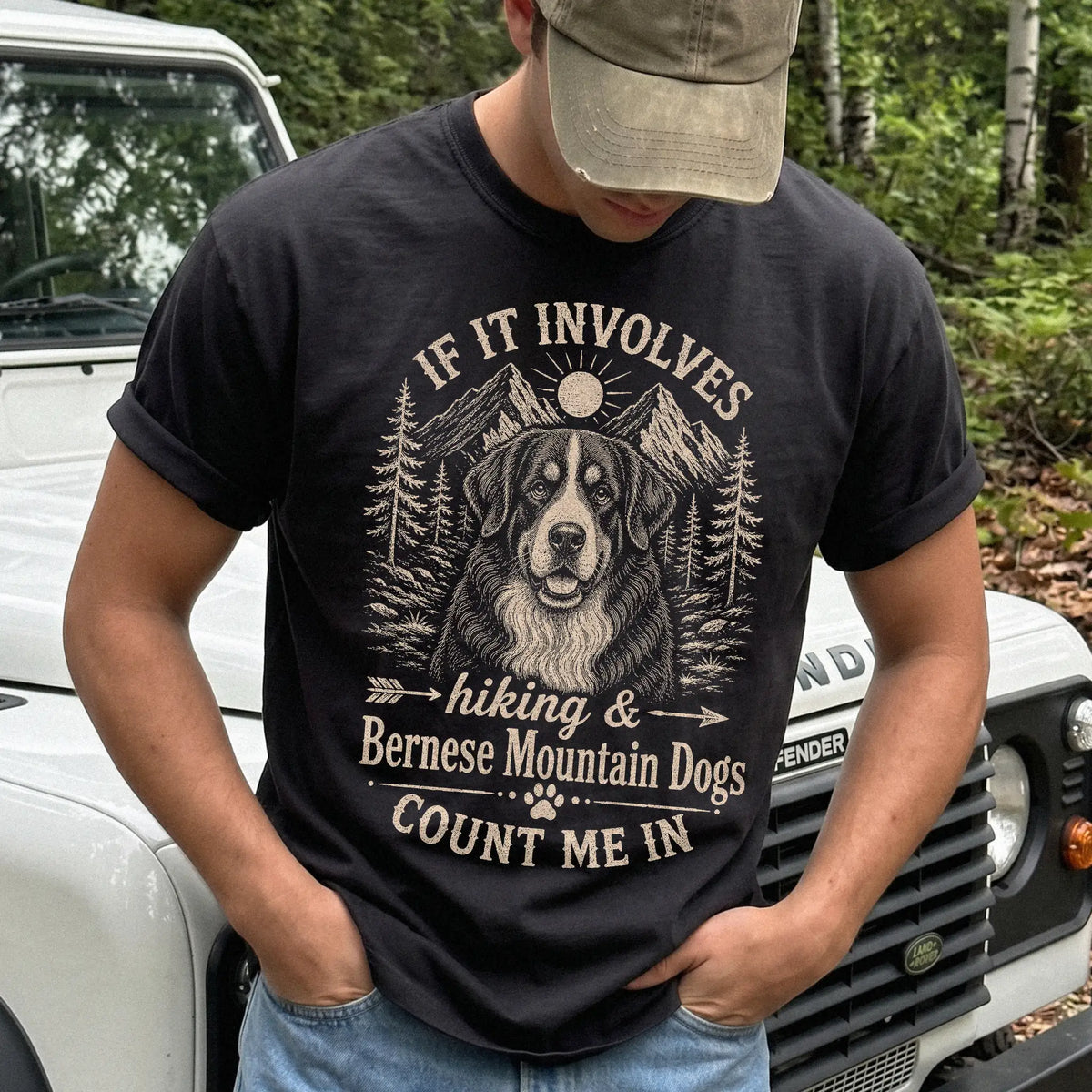Model wearing a Black Comfort Colors® T-shirt featuring Bernese Mountain Dog hiking design with mountain scenery