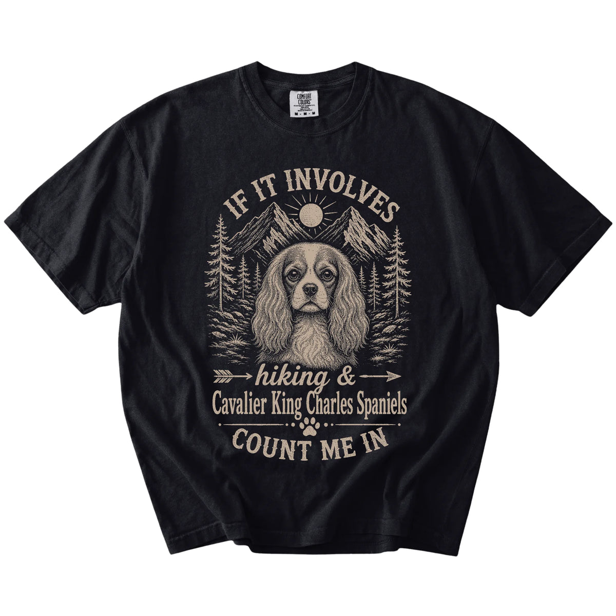 Cavalier King Charles Spaniel hiking design with mountain scenery on a Black Comfort Colors® T-shirt