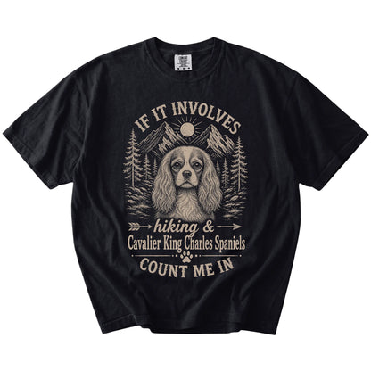 Cavalier King Charles Spaniel hiking design with mountain scenery on a Black Comfort Colors® T-shirt