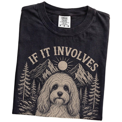 Folded Black Comfort Colors® T-shirt showing Havanese hiking design with mountain scenery