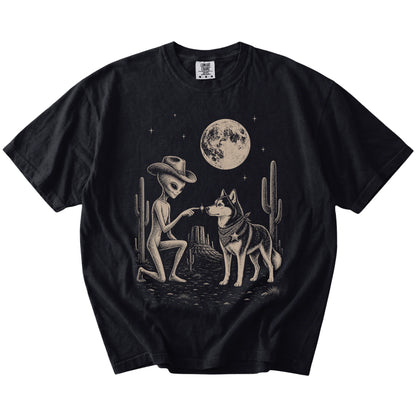 Cowboy alien fist-bumping a Husky beneath the moon on a Black Comfort Colors® T-shirt