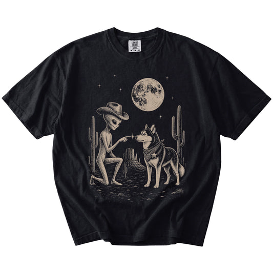 Cowboy alien fist-bumping a Husky beneath the moon on a Black Comfort Colors® T-shirt