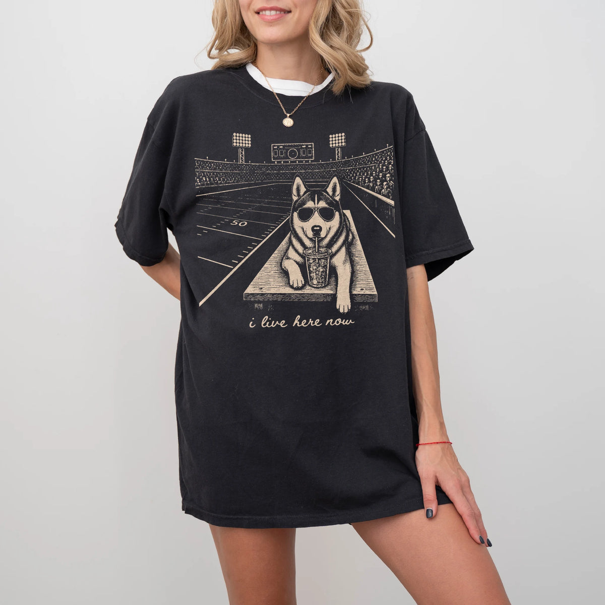 Model wearing a Black Comfort Colors® T-shirt featuring Husky ready for football and tailgate season