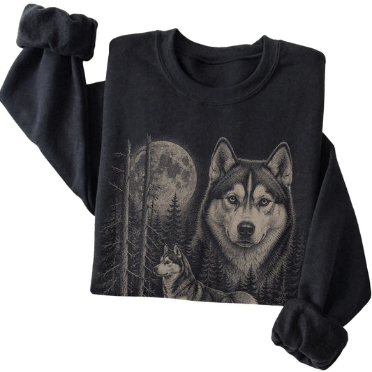 Folded black crewneck sweatshirt showing the Husky Moonlit Forest graphic