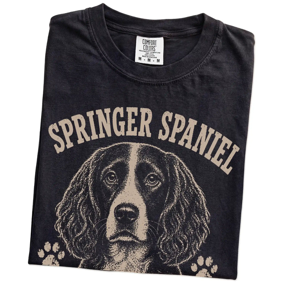 Folded Black Comfort Colors® T-shirt showing Springer Spaniel design with “I Bring The Bounce” lettering