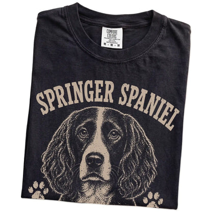 Folded Black Comfort Colors® T-shirt showing Springer Spaniel design with “I Bring The Bounce” lettering