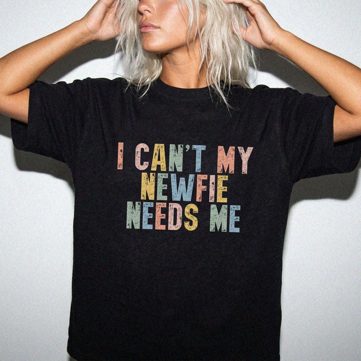 Model wearing a Black Comfort Colors® T-shirt featuring Newfie with “I Can’t, My Dog Needs Me” lettering