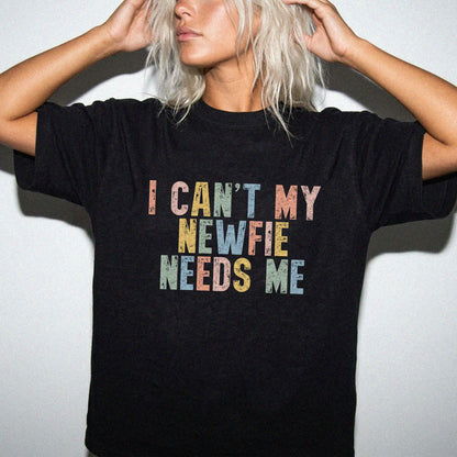 Model wearing a Black Comfort Colors® T-shirt featuring Newfie with “I Can’t, My Dog Needs Me” lettering
