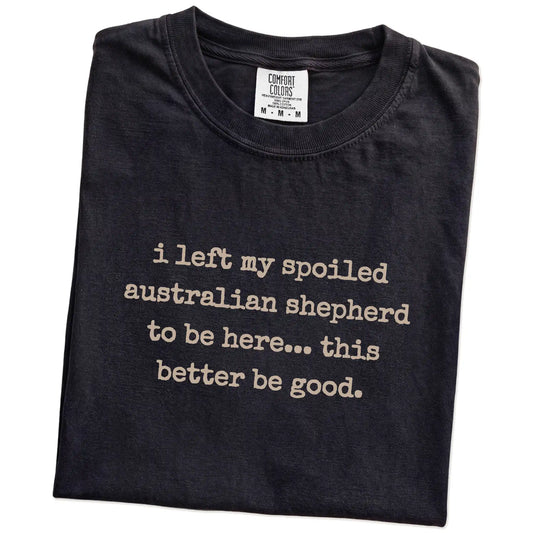 Folded Black Comfort Colors® T-shirt showing Australian Shepherd “I Left My Spoiled Dog Home” saying