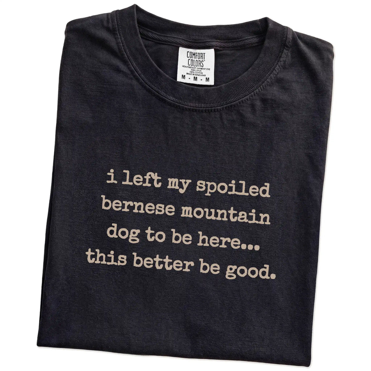 Folded Black Comfort Colors® T-shirt showing the “I Left My Spoiled Bernese Mountain Dog Home” saying